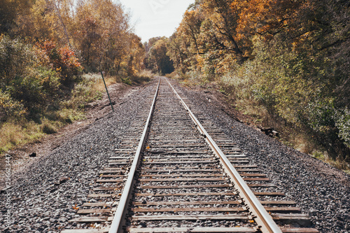Railroad train tracks in rural Minnesota during the fall on a sunny autumn day