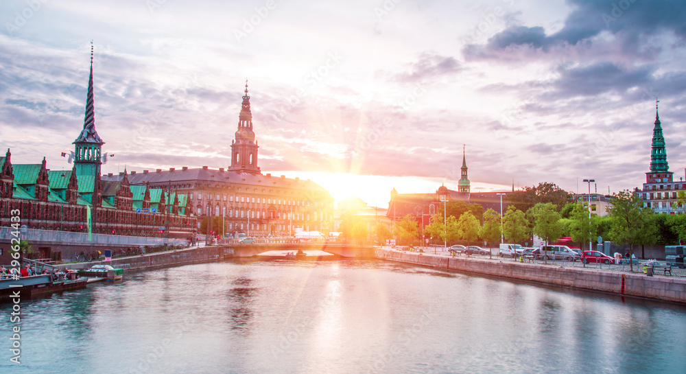 Picturesque spiers of famous historic houses near the water channel in the old center of Copenhagen, Denmark at sunset. Exotic amazing places. Popular tourist atraction.