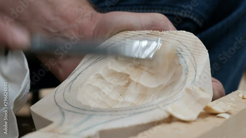 Making a spoon or scoop out of wood. Close-up. Male hands hollow out a wooden product with a woodworking tool. Handwork. Homemade. Do it yourself.