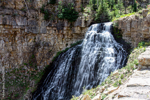 Water cascades over a cliff in Yellowstone National Park