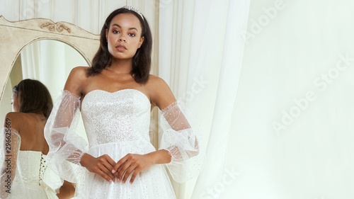 Dark-skinned bride posing in a wedding dress
