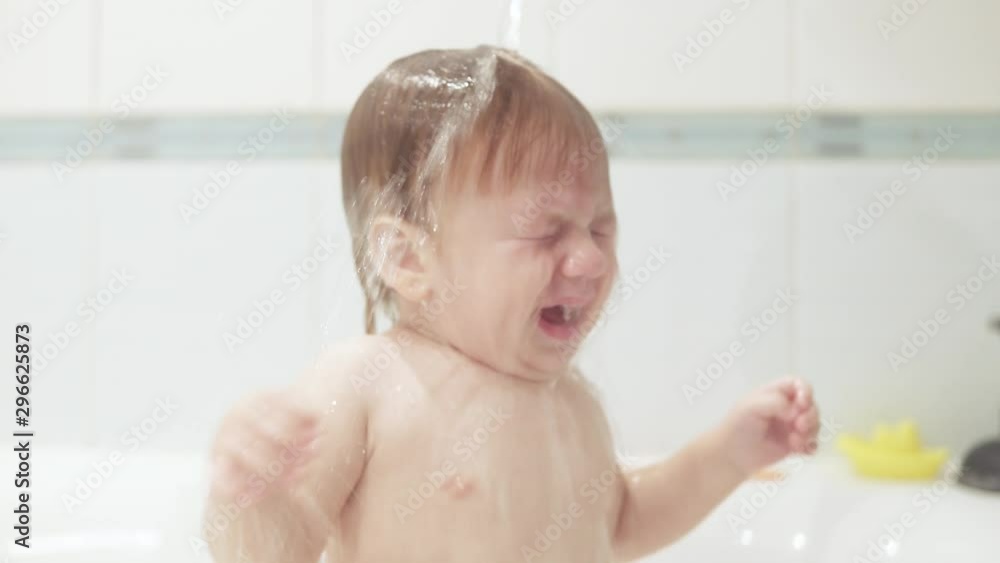 Infant boy doused with water Infant boy doused with water