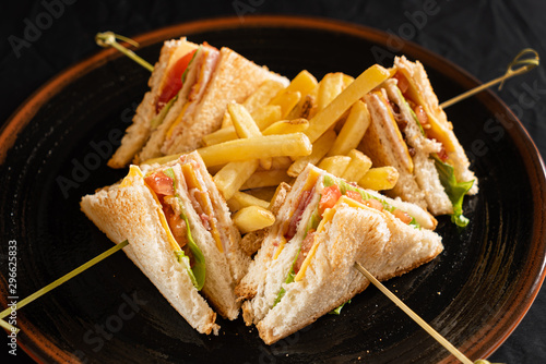 Club sandwiches with smoked salmon and french fries..