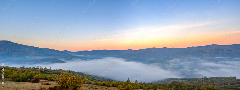 Panorama of the city among the mountains in the fog
