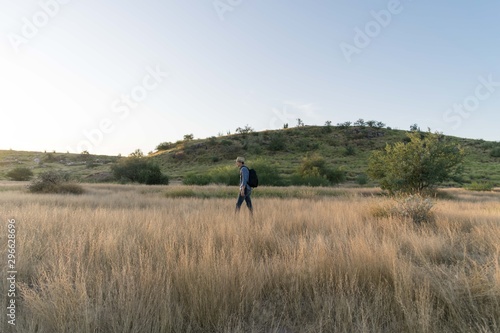 Man walking in natural environment at a sunny afternoon