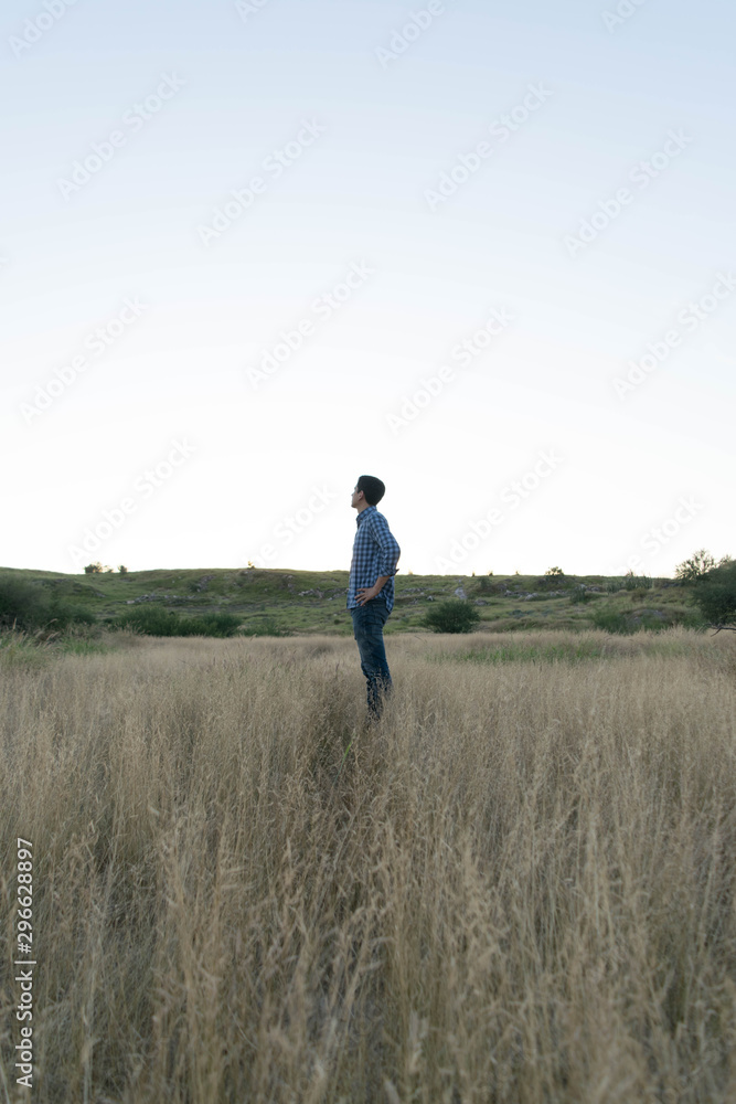 Standing man in natural environment at a sunny afternoon Standing man in natural environment at a sunny afternoon