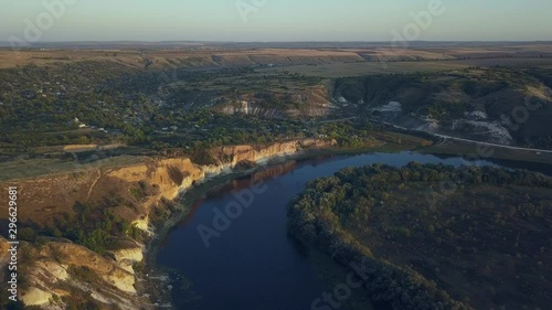 Flight over the river and small village in autumn. Moldova republic of. Molovata village. River Dniester. photo