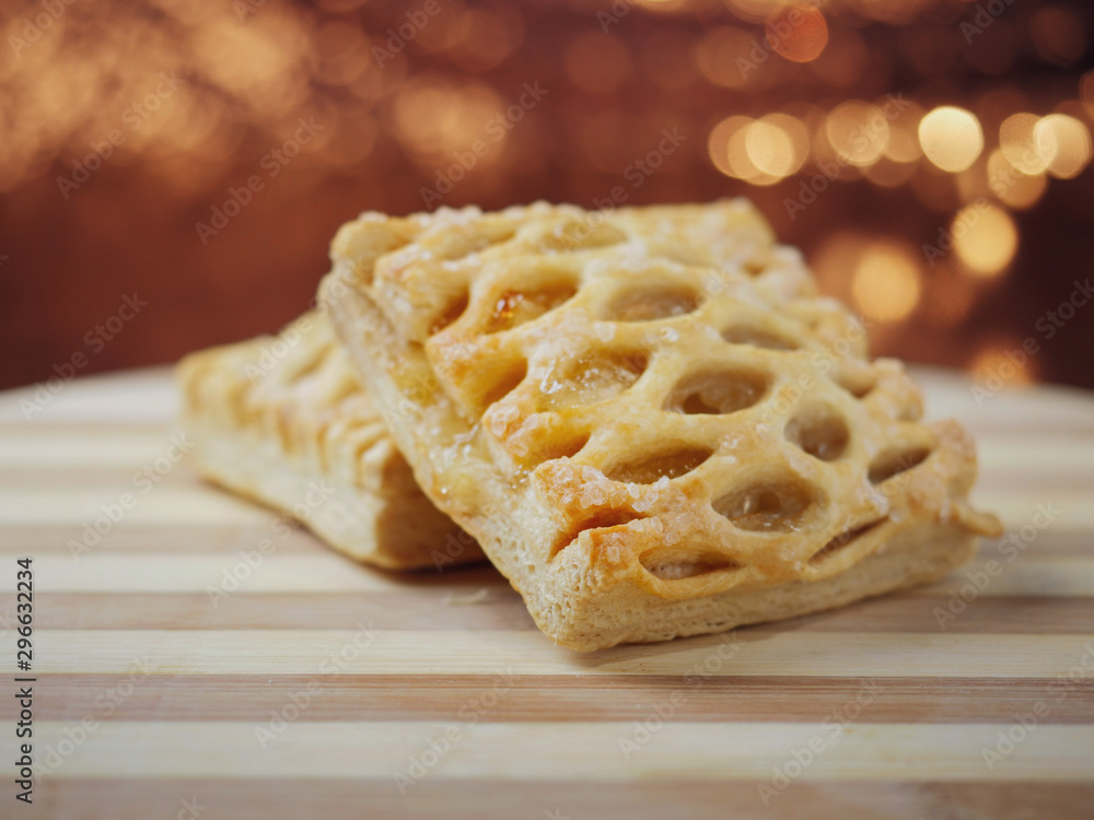 Two apple lattice on a wooden board, warm tones, blurred background. Pastry product. Two apple lattice on a wooden board, warm tones, blurred background. Pastry product.
