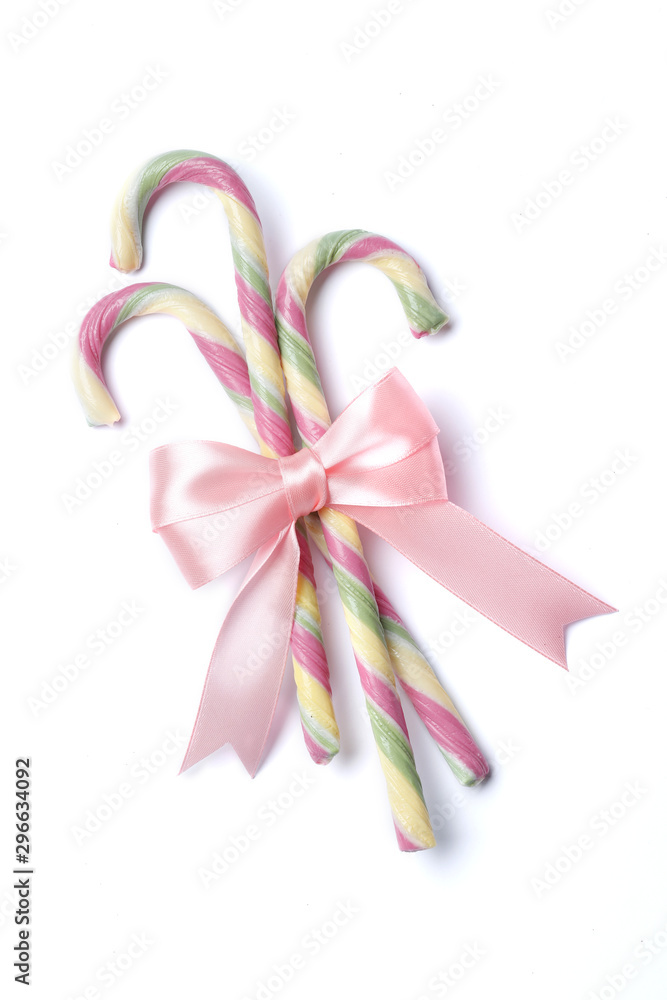 Christmas stylish pink candy cane with bow isolated on a white