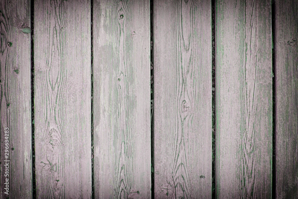 Fototapeta premium Wooden fence from old boards. Background for sites and advertising. Photo with vignette.