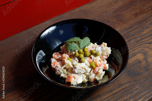 Olivier vegetable salad of home cooking, closeup photo.