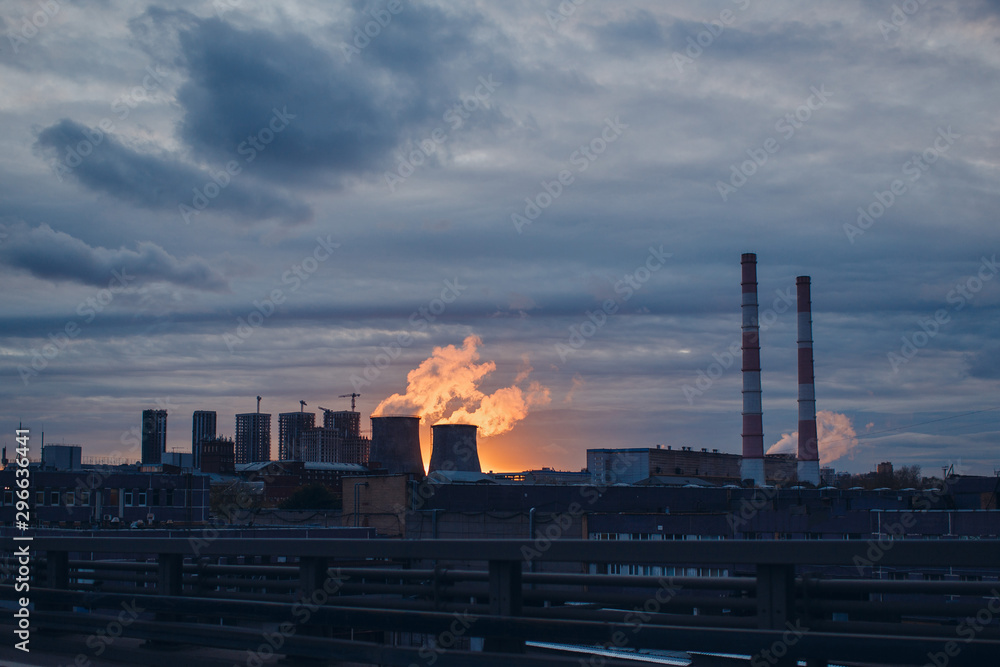 Industrial landscape and smoke from the chimneys on sunset background