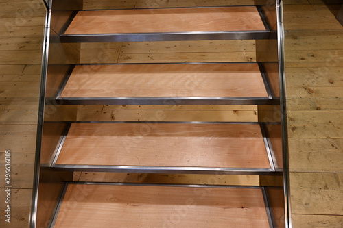 Wooden stairs with metal frame.