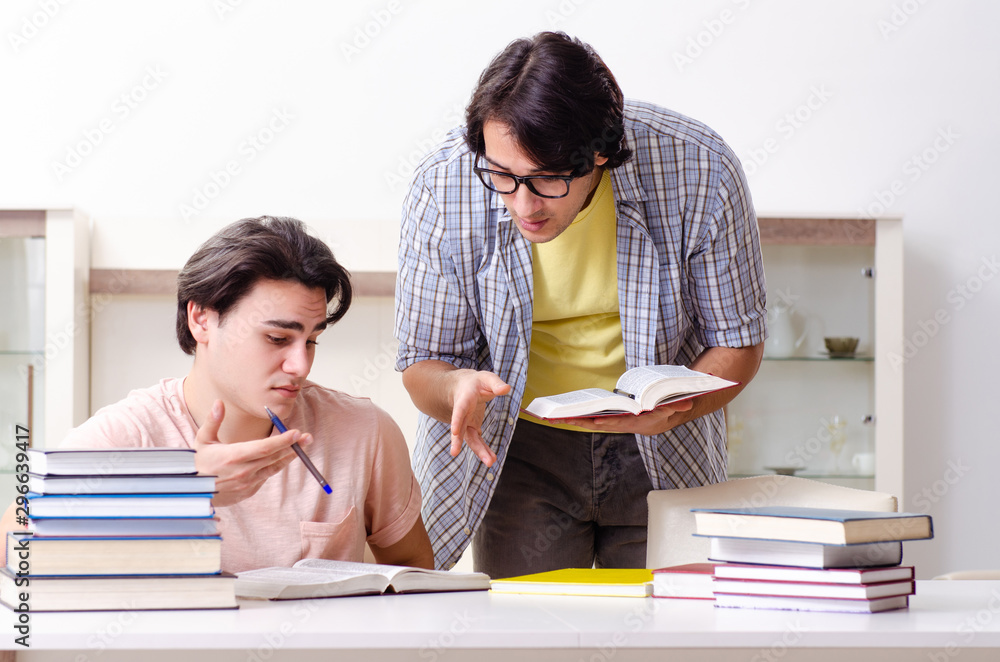 Two male students preparing for exams at home Two male students preparing for exams at home