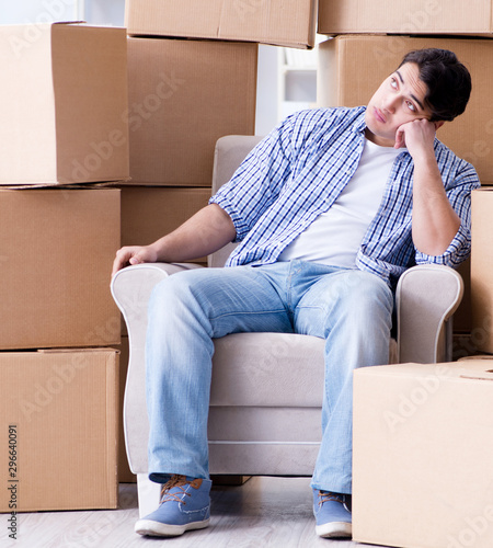 Young man moving in to new house with boxes