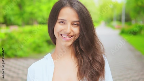 portrait cheefrul smiling young woman posing on the street looking camera have fun photo
