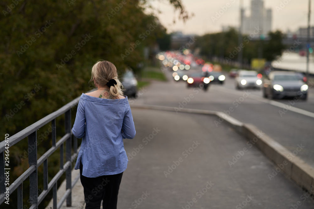 Moscow, Russia - August 09, 2019: A girl walks along the embankment of Moscow Moscow, Russia - August 09, 2019: A girl walks along the embankment of Moscow