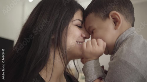 Close-up of a smiling Middle Eastern woman and boy rubbing noses. Happy mother and son expressing love to each other. photo