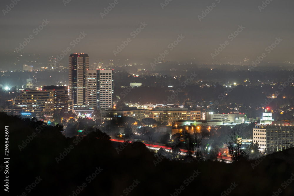 Foggy night view of the Burbank media district in the San Fernando Valley area of Los Angeles, California.  Shot from hilltop in popular Griffith Park.  