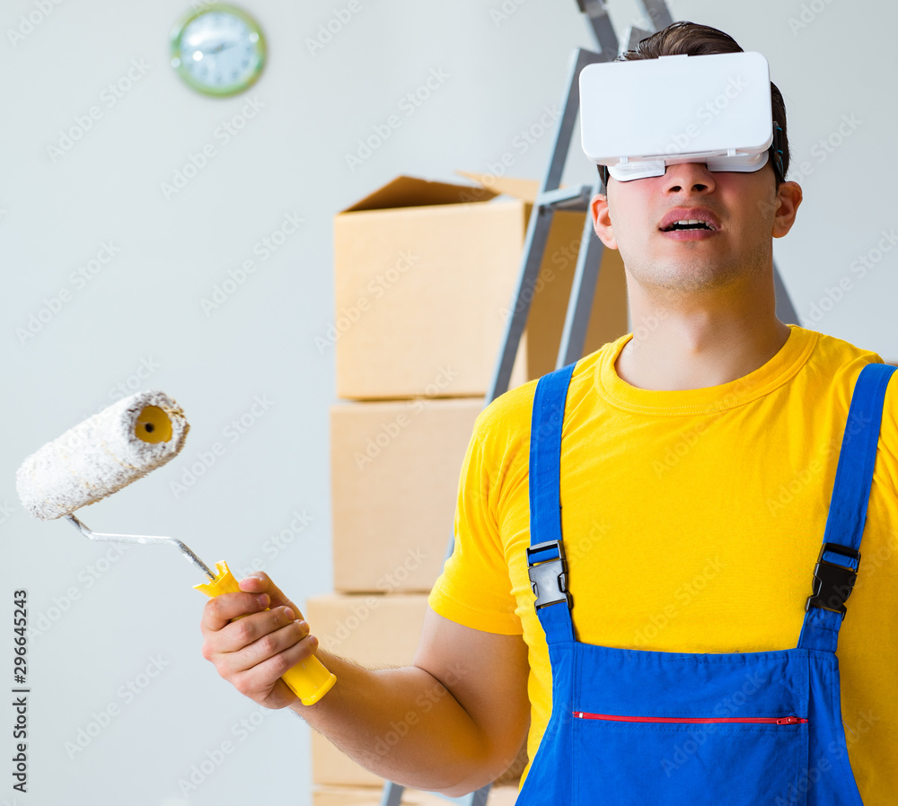 Painter contractor working with virtual reality goggles Painter contractor working with virtual reality goggles