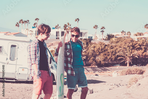 Photography couple of teenagers looking at the same phone and talking together  surftable in