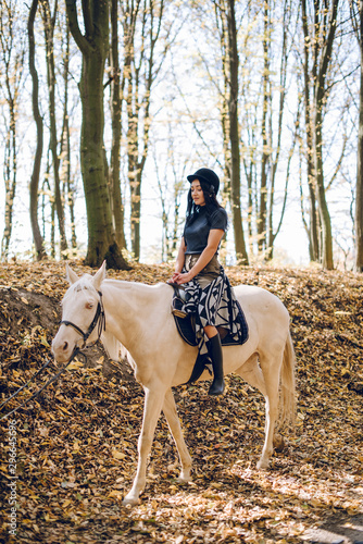 beautiful young girl riding a horse in the autumn forest © Олег Кошевський