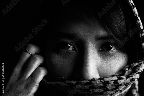 Close-up pictures of sad eyes and faces of Arab women There are freckles on the face and face covering fabric.