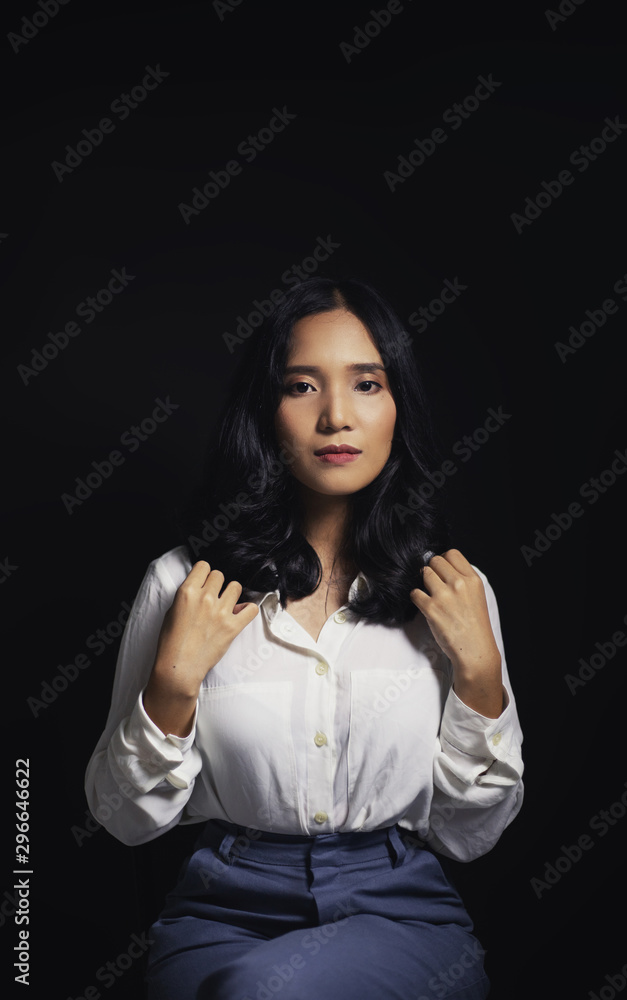 An Asian woman wearing a white long-sleeved shirt with an office style Korean fashion girl Poses shooting on a black background An Asian woman wearing a white long-sleeved shirt with an office style Korean fashion girl Poses shooting on a black background