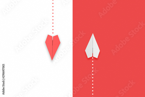 red and white paper airplane flying different directions.different thinking concept photo