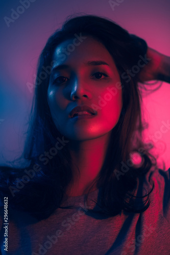 Beautiful woman face. Red and blue light color. Double light colors of potrait.