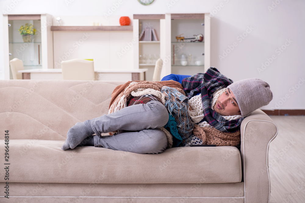 Fototapeta premium Young man suffering at home