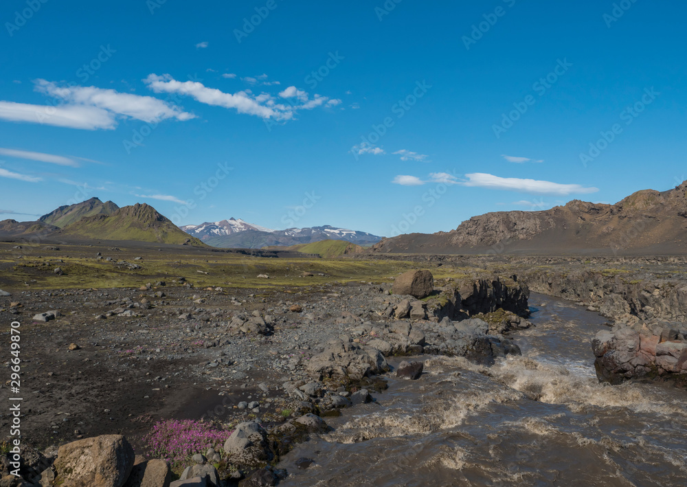 Fototapeta premium Icelandic landscape with canyon of Innri-Emstrura river and view on Tindfjallajokull glacier mountains and green hills. Fjallabak Nature Reserve, Iceland. Summer blue sky