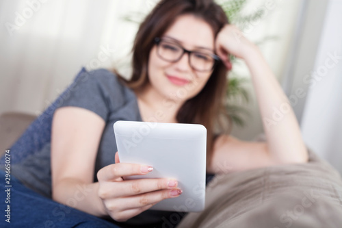 woman using digital tablet at home