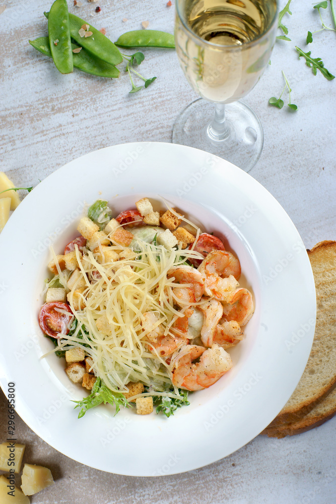 Caesar salad with shrimp on the table Caesar salad with shrimp on the table