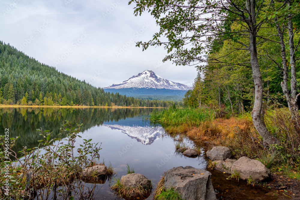 Mt. Hood reflecting in Trillium Lake with rocks and trees in an idyllic scene Mt. Hood reflecting in Trillium Lake with rocks and trees in an idyllic scene