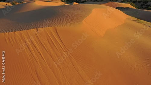 Aerial top view on sand dunes in desert at sunrise, 4k photo