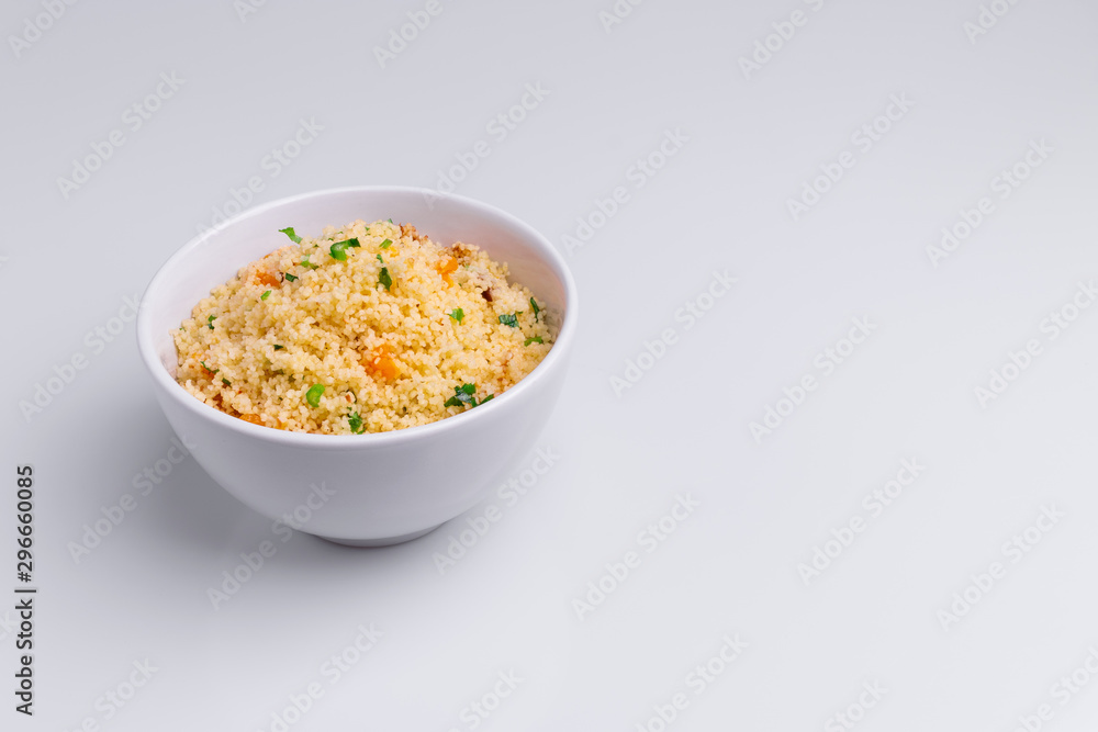 Delicious homemade vegetarian couscous with dates, raisins, parsley, tomato, lemon and olive oil in a white bowl on white background, Traditional Moroccan and Arabic Salad Tabbouleh Delicious homemade vegetarian couscous with dates, raisins, parsley, tomato, lemon and olive oil in a white bowl on white background, Traditional Moroccan and Arabic Salad Tabbouleh