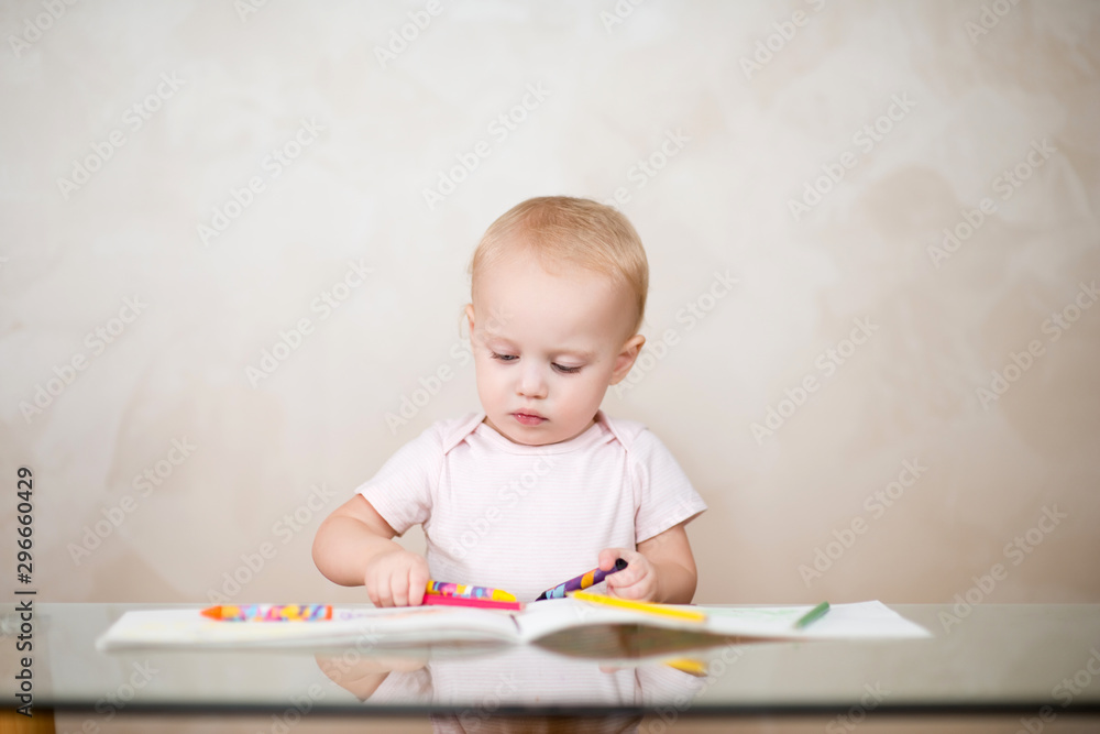 little baby girl chooses a pencil for drawing in an album little baby girl chooses a pencil for drawing in an album