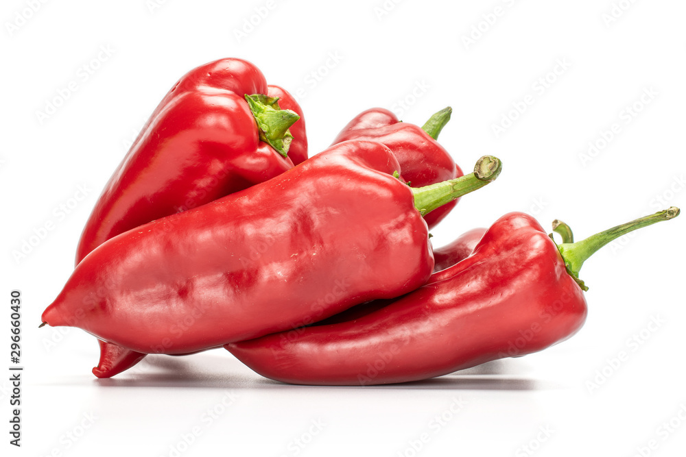 Group of four whole bright sweet red bell pepper isolated on white background
