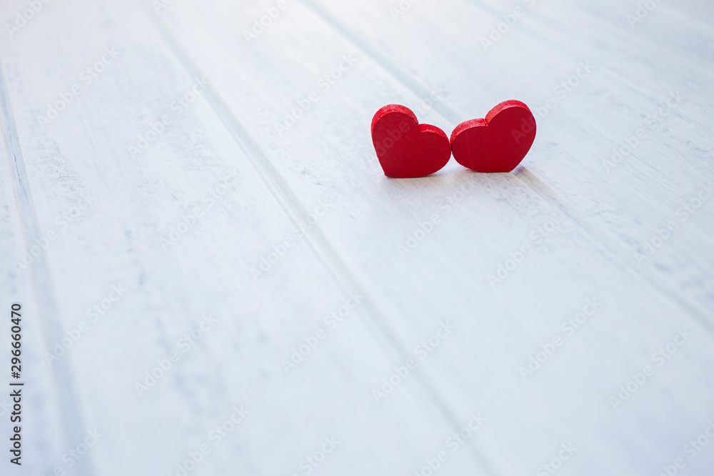 Red wooden hearts on white wood