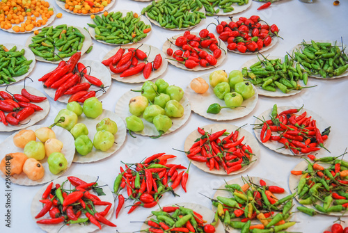 Different types of chiles in piles for sale in the agricultural market. photo