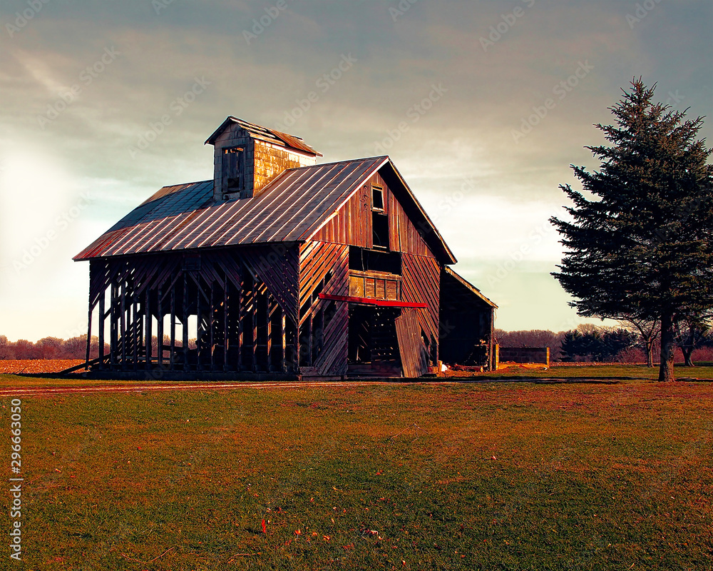 Fototapeta premium Photo of an old abandoned barn in the country with a dark sky.