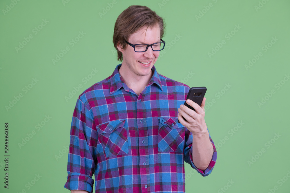 Happy young handsome hipster man with eyeglasses using phone Happy young handsome hipster man with eyeglasses using phone