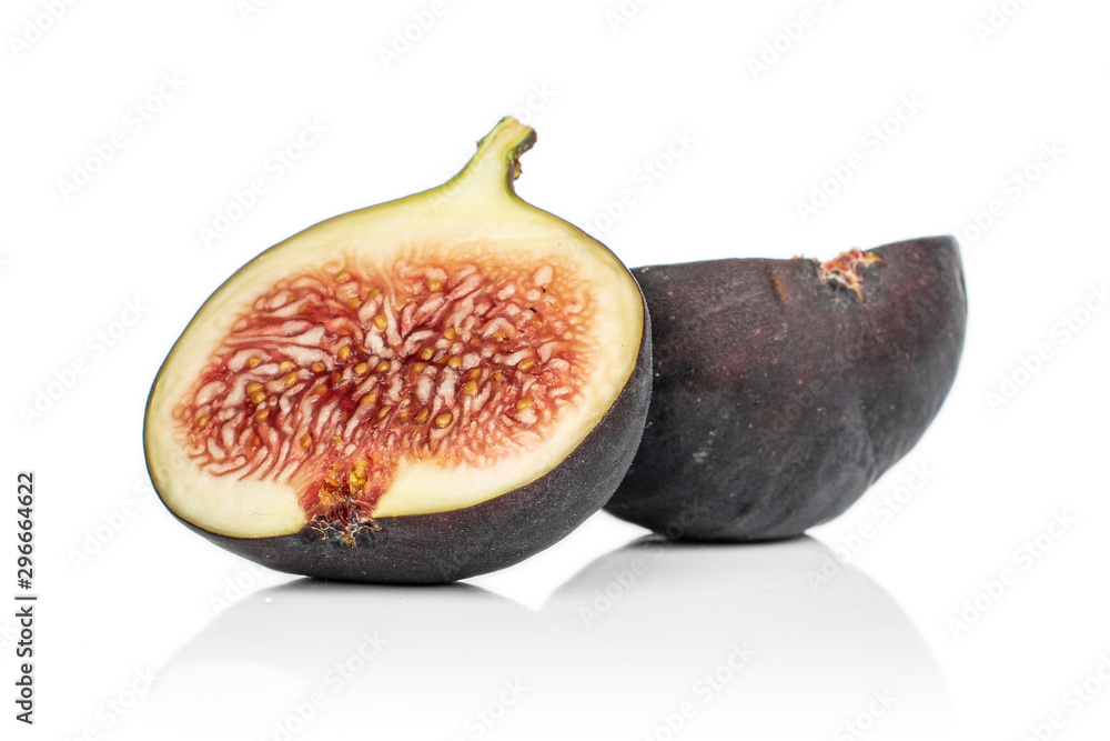 Group of two halves of sweet purple fig isolated on white background
