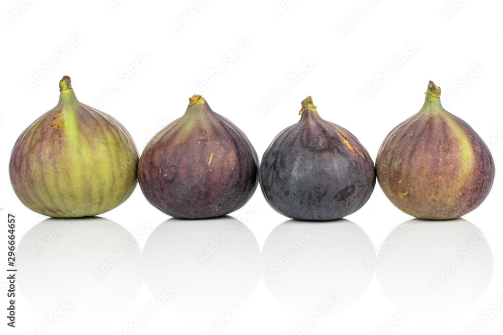 Group of four whole sweet purple fig isolated on white background Group of four whole sweet purple fig isolated on white background