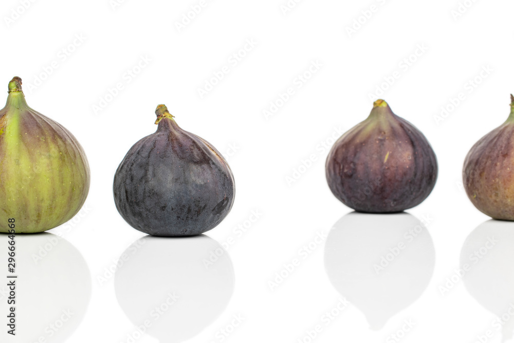 Group of four whole sweet purple fig isolated on white background Group of four whole sweet purple fig isolated on white background