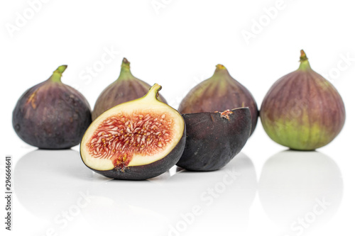 Group of four whole two halves of sweet purple fig isolated on white background