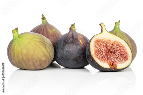 Group of four whole one half of sweet purple fig isolated on white background