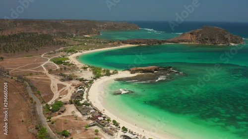 The white sand beach of Tanjung Aan in Lombok, Indonesia during a sunny day. Aerial shot. photo