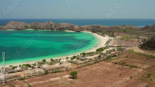 The white sand beach of Tanjung Aan in Lombok, Indonesia during a sunny day. Aerial shot. photo